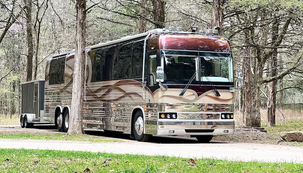 A 2001 Angola XLII motorhome on a Prevost shell, with an enclosed trailer behind it